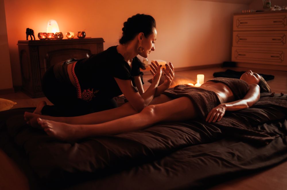 woman is sitting bed with woman bed candle her
